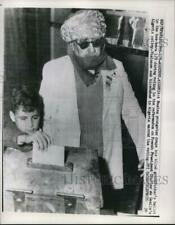 1961 Press Photo Moslem Youngster drops his blind grandfathers vote in ballot